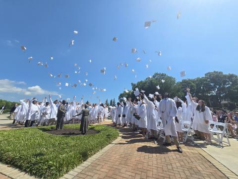 Enoch Autry/The Clayton Tribune.  A record number of seniors graduate during the morning of Sunday, May 17, at the Rabun Gap-Nacoochee School as 107 toss their caps into the air in celebration. 