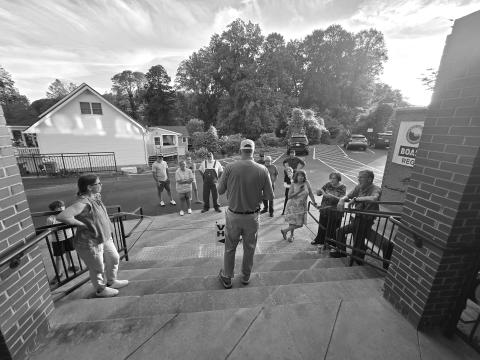 Enoch Autry/The Clayton Tribune. Candidates for Rabun County commission and magistrate judge listen to John Bradshaw announce some of the election numbers on Tuesday evening.