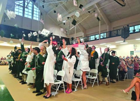 Enoch Autry/The Clayton Tribune.  The graduating class of the Tallulah Falls School toss their caps into the air at the conclusion of the May 22 commencement inside the TFS Lower/Middle School Campus Activity Center. 