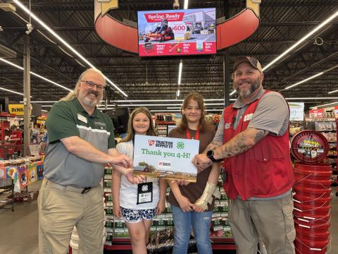 Photo courtesy of Rabun County 4-H. Rabun County 4-H Educator Joey Eller receives a gift card from Clayton Tractor Supply Company Manager Ricky Albright, as 4-H’ers Maleigha Beck and Karsen Pendrey observe.