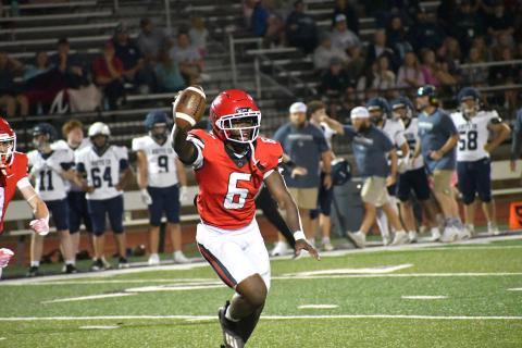 Wesley Branch/The Clayton Tribune. Rabun County junior linebacker JK Fruster shows off the football to the Wildcat sideline after intercepting a White County pass with 2:01 to play. Fruster’s interception helped set up kicker Bryan Avila’s winning field goal as time expired. 