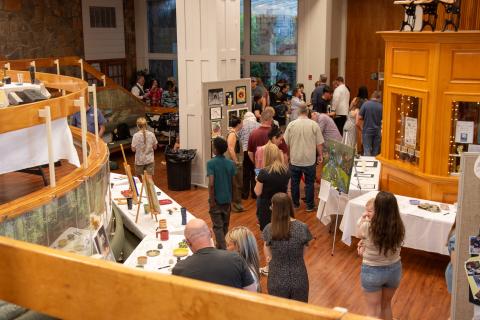 Photo courtesy of Elisha Boggs. Guests visit the Evening of the Arts packed with artwork, culinary art delights, demonstrations, music, and song. 