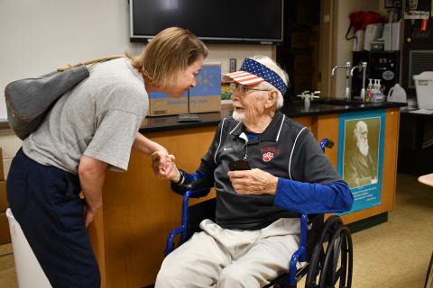 Megan Horn/The Clayton Tribune. Rabun County High School Class of 1989 Kelli Marcus Wayne shares words of heartfelt gratitude with former science teacher Clayton Croom, 97, in his old classroom during the May 16 walkthrough down memory lane. Wayne told Croom that he was an inspiration for her. 