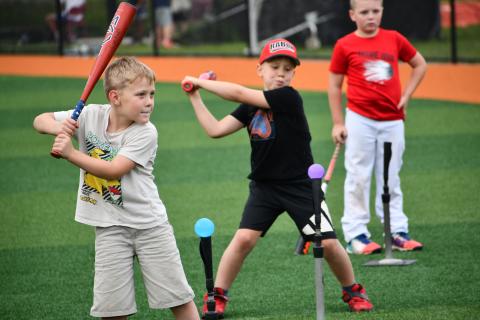 Wesley Branch/The Clayton Tribune. Campers practiced their swing on water-ballon like balls that exploded with water upon contact.