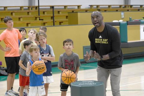 Wesley Branch/The Clayton Tribune. Rabun Gap-Nacoochee School head boys basketball coach Devin Liferidge leads campers in shooting drills during Rabun Gap’s kids basketball camp on June 8. Liferidge is entering his second season as the head boys basketball coach for the Eagles. 