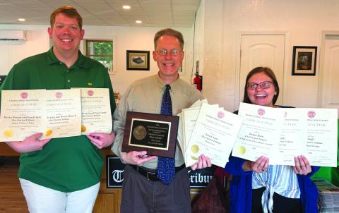 Katie Hamby/The Clayton Tribune. The Clayton Tribune won 13 awards from the Georgia Press Association on June 12 at the Better Newspaper Contest on Jekyll Island. Overall, the Tribune finished third in General Excellence. Pictured are Sports Editor Wesley Branch, Publisher Enoch Autry and News Editor Megan Horn showing the honors as media members from Oklahoma and Louisiana judged the Georgia categories.
