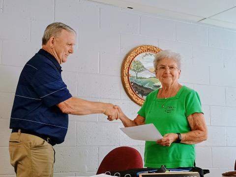 Megan Horn/The Clayton Tribune. Mountain City Mayor Grace Watts, right, shakes hands and congratulates C.L. Faulkenberry as the newest council member on June 9. 