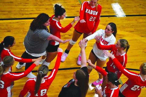 Enoch Autry/The Clayton Tribune. Rabun County Head Coach April Jones, left, connects with her volleyball players in 2025 during a home game early in the season.