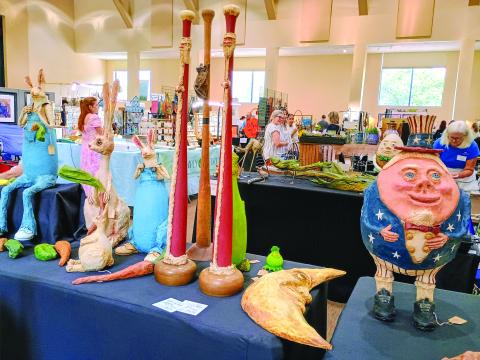 Megan Horn/The Clayton Tribune. Paper mache artist Judy Schmidt with her “Paper Trails” is this year’s winner of the Painted Fern Art Festival “Peoples’ Choice Award for Best in Show.” Her booth featured many of her paper mache characters including cartoon character “Humpty Dumpty,” a crescent moon, rabbits and many others. 