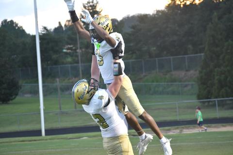 Wesley Branch/The Clayton Tribune. Rabun Gap offensive lineman Wilder Brasher lifts wide receiver Joshua Davis in the air in celebration after Davis’ 60-yard touchdown reception during Rabun Gap’s scrimmage versus Westside (S.C.) on Aug. 14. Davis’ long touchdown grab from quarterback Grayson Clary tied the scrimmage, 13-13. 