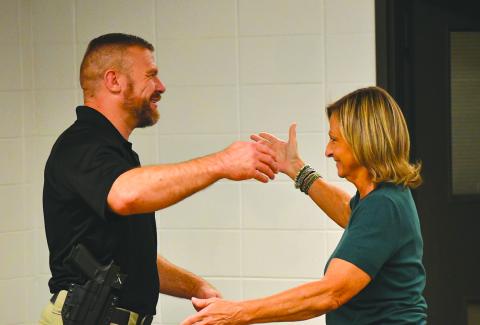 Enoch Autry/The Clayton Tribune. Clayton City Manager Trudy Crunkleton (right) prepares to give Kevin Marsteller a hug after the city council unanimously approved the current major with the Corneila Police Department as Clayton’s new police chief. Marsteller will succeed Michael Turner, who has announced his resignation effective Aug. 28.
