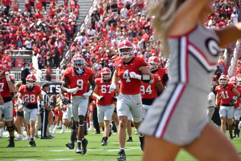 Wesley Branch/The Clayton Tribune. The Georgia football team runs onto the field ahead of its home-opening game versus Marshall last season. The Bulldogs, who open the new season versus Tennessee State on Sept. 5, earned the No. 3 ranking in the preseason Associated Press poll. 
