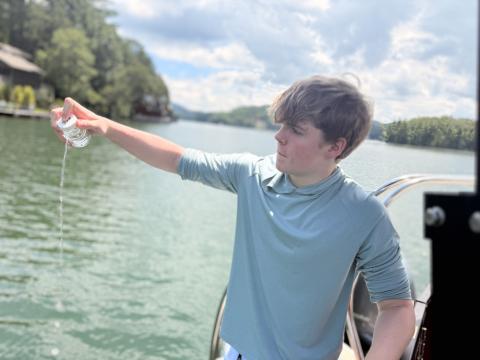 Submitted photo. Henry Dumas collects water from Lake Burton, which he will take back to test for E. Coli levels in the IDEXX laboratory on the TFS campus. 