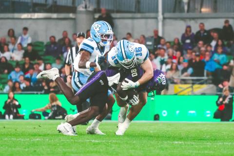 Photo via Christian Proscia, NewEraPrep. Current North Carolina and former Rabun Gap defensive back Coleman Bryson (No. 16, center) makes a tackle on TCU wide receiver Jacobe Hayes during the Tar Heels’ 15-10 win over TCU on Aug. 29 in Ireland. Bryson finished the win with two tackles and a pass breakup. 