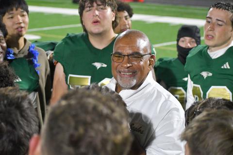 Wesley Branch/The Clayton Tribune. Rabun Gap defensive line coach Joe Crosby smiles as the RGNS football team wishes him a happy 70th birthday after their regular season win over Christ School last season. Crosby has been coaching at Rabun Gap for six years.
