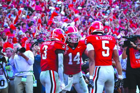 Photography by Wesley Branch/The Clayton Tribune. Former Rabun County and current UGA quarterback Gunner Stockton celebrates with teammates Nate Frazier Jr. (left) and Noah Thomas (right) after scoring a rushing touchdown during Georgia’s 43-35 win over Ole Miss at Sanford Stadium on Oct. 18, 2025. Stockton is heading into his final season of college football and his second season as Georgia’s starting QB