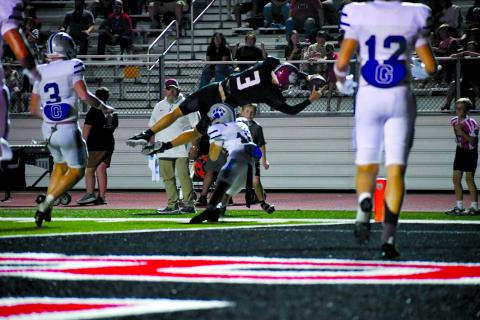 Enoch Autry/The Clayton Tribune. Rabun County quarterback Cooper Kowalsky goes airborne at the goal line to pick up extra yardage against Gilmer on Sept. 18. Kowalsky would come up just short of the end zone and running back JK Fruster would punch it in for the score on the ensuing play in the Wildcats’ 53-52 overtime loss. 