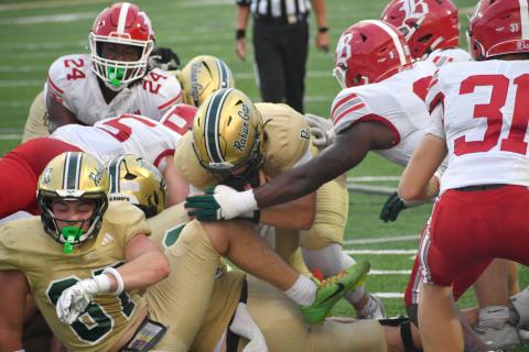 Wesley Branch/The Clayton Tribune.  Rabun Gap quarterback Grayson Clary (center) pushes forward for a touchdown on a quarterback sneak in Rabun Gap’s 51-33 Sept. 4 loss to Baylor. Clary and the Eagles are still searching for their first win of the new season.