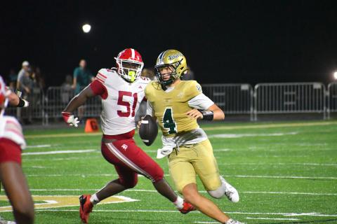 Wesley Branch/The Clayton Tribune. Rabun Gap quarterback Grayson Clary evades Baylor defenders during Rabun Gap’s 51-33 loss to Baylor on Sept. 4. Clary threw for 413 yards and scored three total touchdowns in the Eagles’ loss.