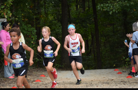 Submitted Photo. Alden English with the Rabun County Recreation Department sprints to the cross country finish line.