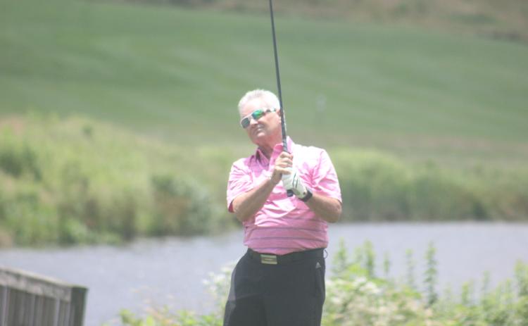 Jay Anderson watches his shot during the Sid Weber Memorial Cancer Fund golf tournament at Sky Valley Country Club last Wednesday. (Photo by Glendon Poe/The Clayton Tribune)
