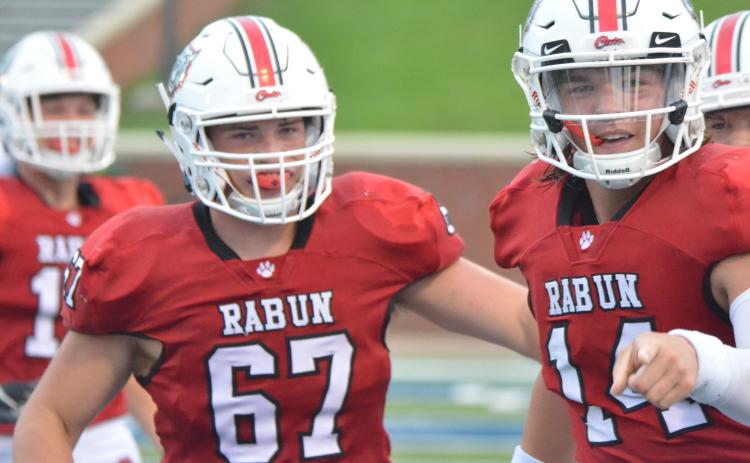 Rabun County offensive lineman Will Hightower (67) and quarterback Gunner Stockton (14) celebrate after a touchdown during the first half against Bremen in the Erk Russell Classic at Georgia Southern’s Paulson Stadium in Statesboro last Saturday night. (Wayne Knuckles/The Clayton Tribune)