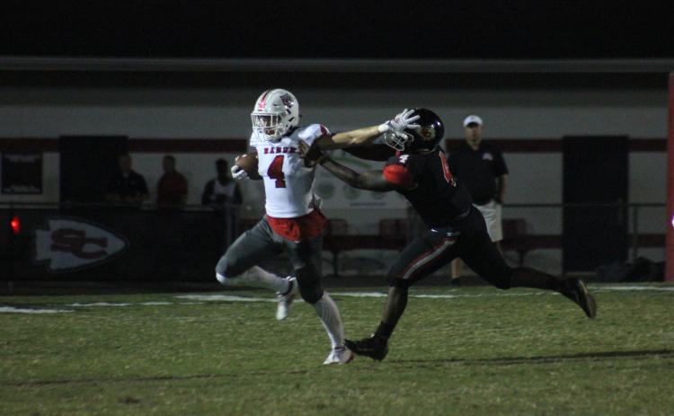 Rabun County wide receiver Braxton Hicks, left, stiff-arms Stephens County tight end Kenny Davis during the first half in Toccoa last Friday night. (Glendon Poe/The Clayton Tribune)