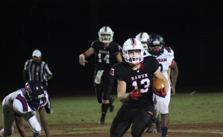 Rabun County running back Brody Jarrard (13) carries the ball behind blockers during the first half against Putnam County at Frank Snyder Memorial Stadium in Tiger last Friday night. (Glendon Poe/The Clayton Tribune)