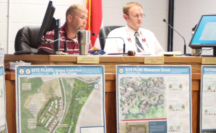 Megan Broome/The Clayton Tribune. Mayor Green, left, and city attorney Mitch Baker listen as Heather Feldman, representative from Georgia Mountains Regional Commission (GMRC), talks to city council members about GMRC’s plan to update the city of Clayton’s Charter and the Clayton city council meeting Tuesday.