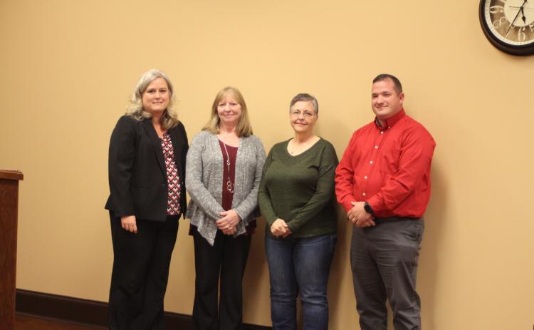 Megan Broome/The Clayton Tribune. Superintendent April Childers, left, Marsha Smith, Donna Headrick, bus driver, and Marty Dixon, transportation director recognize Smith for her 33 years of dedication to Rabun County Schools at the Board of Education meeting on Thursday, Oct. 17.