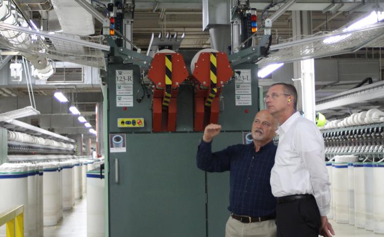 Weldon Wahl, plant manager for the Parkdale Rabun Gap facility, takes Rep. Doug Collins, who represents Georgia’s 9th congressional district, on a tour of the Parkdale textile plant in Rabun County last Thursday. Wahl showed Collins the automated machinery inside the facility and introduced him to some of Parkdale’s employees. Parkdale is one of the largest providers of spun yarns in the world.