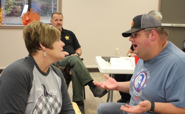 Lt. Misty Houston, Rabun County Emergency Medical Services, and Deputy Andy Beck help sort out people’s problems by walking through an example narrative of a peer in a crisis situation during a scenario-based workshop at Peer Support training held at Tabernacle Baptist Church last Monday.