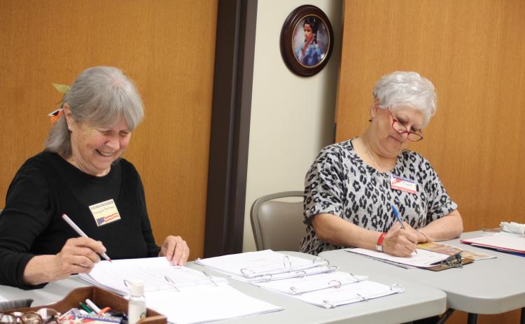Annabelle Barkman, left, and Jan Timms check people in and verify voter registrations for residents who participate in early voting at the Rabun County Board of Elections Office on Monday. Early voting ends Friday, Nov. 1.