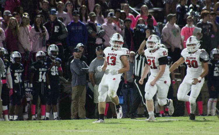 Rabun County linebacker Brody Jarrard (13), defensive lineman Phillip Roberson (21) and linebacker Hoff Windham celebrate after Jarrard’s tackle for a loss during the first half against Elbert County at the Granite Bowl in Elberton last Friday night. (Glendon Poe/The Clayton Tribune)