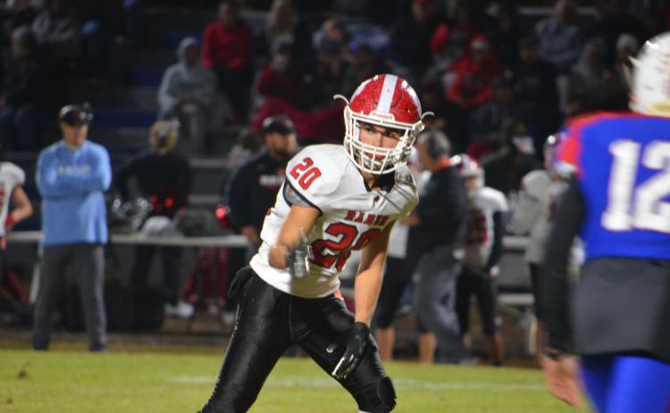 Wayne Knuckles/The Clayton Tribune. Junior wide receiver Sutton Jones (20) checks his spot with the referee against Oglethorpe last Friday night.