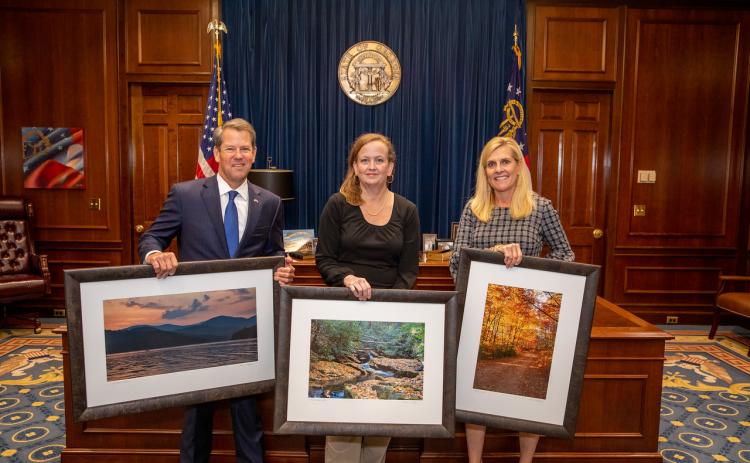 Rabun County photographer Michele Crawford, center, with Gov. and Mrs. Brian Kemp.