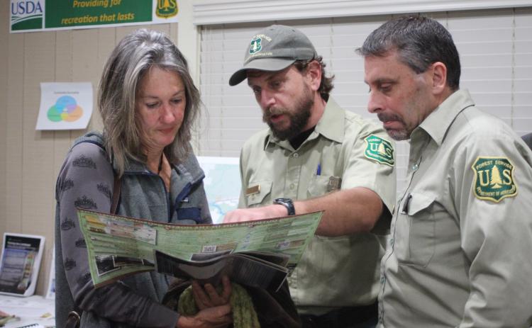 Megan Broome/The Clayton Tribune. Terri Jagger Blincoe, left, discusses the United States Forest Service Foothills Landscape Project with Phillip Waldrop, United States Forest Service, and Derek Fusco, Chattahoochee-Oconee National Forests.