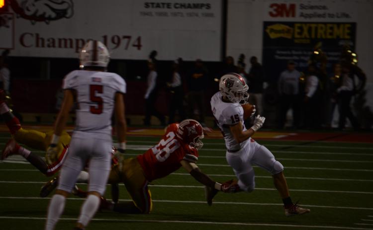 Wayne Knuckles/The Clayton Tribune. Senior Sam Adams (15) eludes a Thomasville defender Friday night.