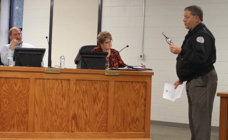 Megan Broome/The Clayton Tribune. Brendan Thompson, right, general manager for the Rabun County Water and Sewer Authority, discusses a partially unpaid August 2019 water bill for the city of Clayton with Council Members at their meeting on Tuesday.