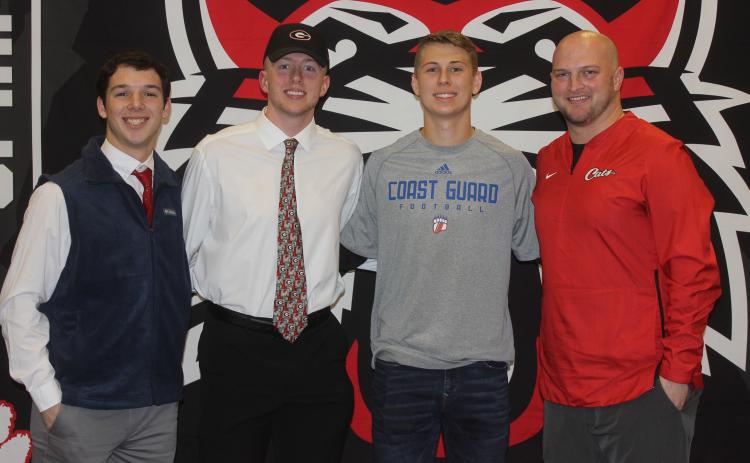 Andy Diffenderfer/The Clayton Tribune From left are Sam Adams, Braxton Hicks, Garrett Bragg and Rabun County High head football coach Jaybo Shaw on National Signing Day Feb. 5 at the school.