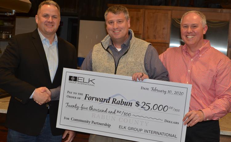 Wayne Knuckles/The Clayton Tribune Todd Webb, left, COO of Elk International, presents a check for $25,000 to Development Authority of Rabun County Board Chairman Claude Dillard (center) and Forward Rabun Director Rick Story at a recent meeting.