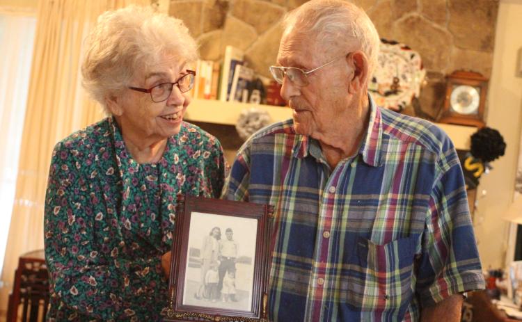 Megan Broome/The Clayton Tribune. Clara and Earl Zoellner of Dillard celebrated their 75th wedding anniversary this week. They were married in 1945 in Clarkesville. Above, the couple holds a picture of themselves with their children, Stanley and Gail, when they were young.