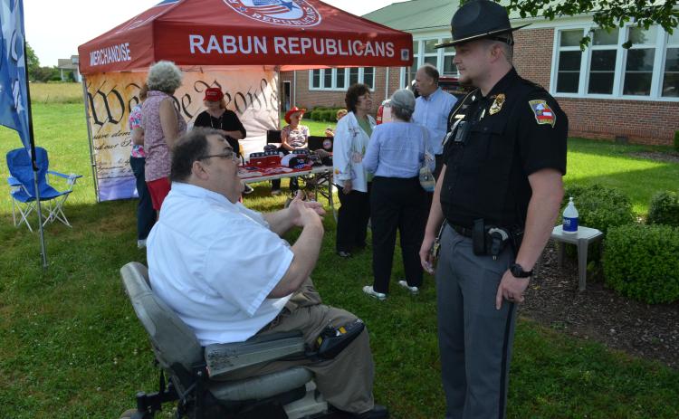 Wayne Knuckles/The Clayton Tribune. Ed Henderson, left, secretary of the Rabun County Republican Party, talks with Dillard Police Chief Jeremy Parker Saturday morning.