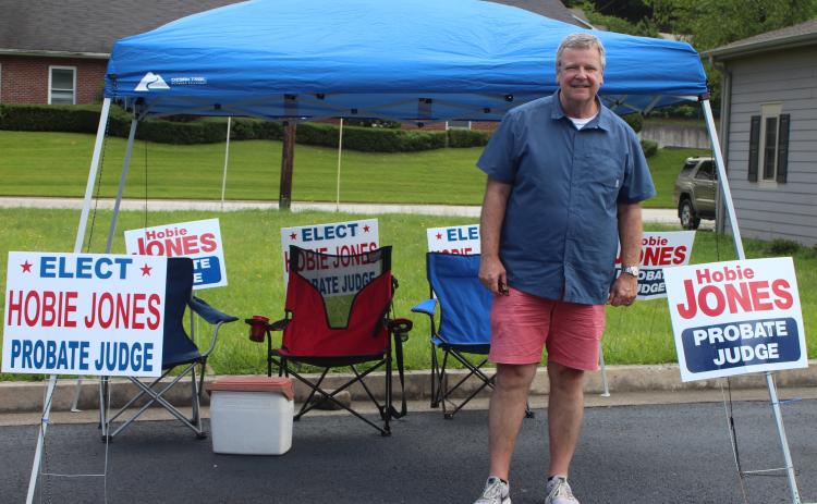 Megan Broome/The Clayton Tribune. Candidate Hobie Jones sets up his tent outside the Civic Center and greets voters as they head to the polls for the primary election on Tuesday.