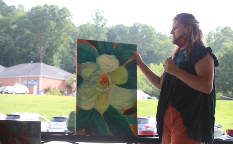 Megan Broome/The Clayton Tribune. Sarah Decker, 2020 graduate of Rabun County High School, presents her future plans and discusses the inspiration behind her artwork to the North Georgia Arts Guild at their meeting last Thursday.
