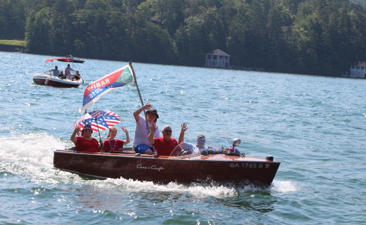 Megan Broome/The Clayton Tribune. The Lake Rabun Association held their annual wooden boat parade on Sunday as part of Fourth of July celebration events to bring the community together.. The wooden boat parade featured rare boats and boats ranging from the 1920s to 1970s.