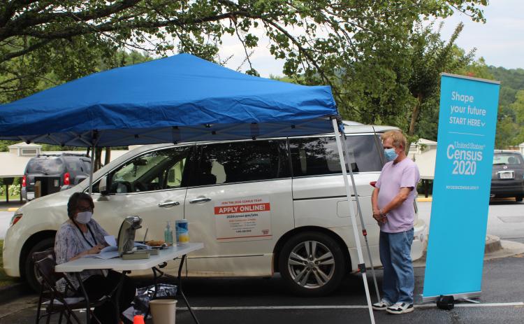 Megan Broome/The Clayton Tribune. Terrell Wilson, right, gets assistance about the 2020 Census from Denica McCurdy, Census Response Representative (CRR) and Mobile Questionnaire Assistant (MQA) for the 2020 Census. A tent was set up at the Rabun County Public Library Monday and Tuesday to help Rabun residents learn more about the 2020 Census and assist with any questions they had.