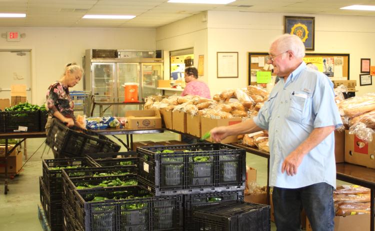 Megan Broome/The Clayton Tribune. Carl Green works to move boxes and organize food to be distributed to residents of the community at the American Legion Post 220 food distribution last Thursday.