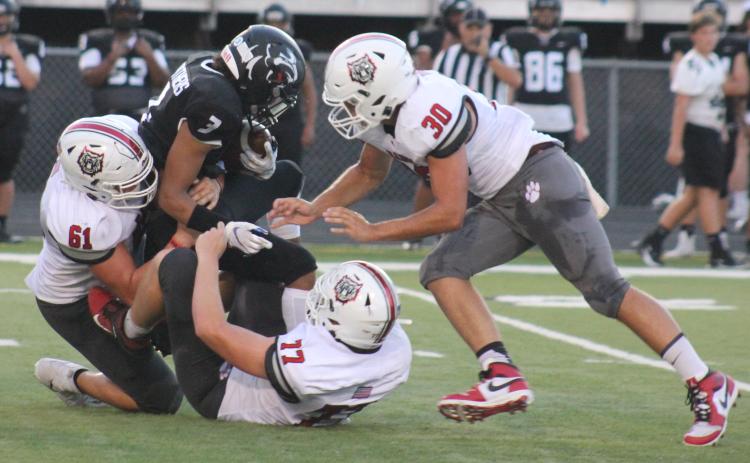 Andy Diffenderfer/The Clayton Tribune. Ridgeland running back KeSean Eubanks goes nowhere as Wildcat defenders Will McCraw, Chris Thompson and Hoff Windham pounce last Friday in Rossville.