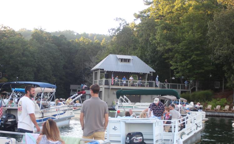 Megan Broome/The Clayton Tribune. Hundreds of boaters turned out for a concert by the Atlanta duo of Banks and Shane Saturday to mark the 100th birthday of Lake Burton.